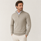Man styling the beige quarter-zip sweater outdoors
