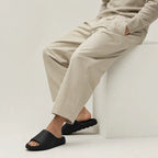 Black EVA platform slide slippers worn while seated