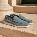 Bellaro petrol-blue suede loafers on Mediterranean travertine
