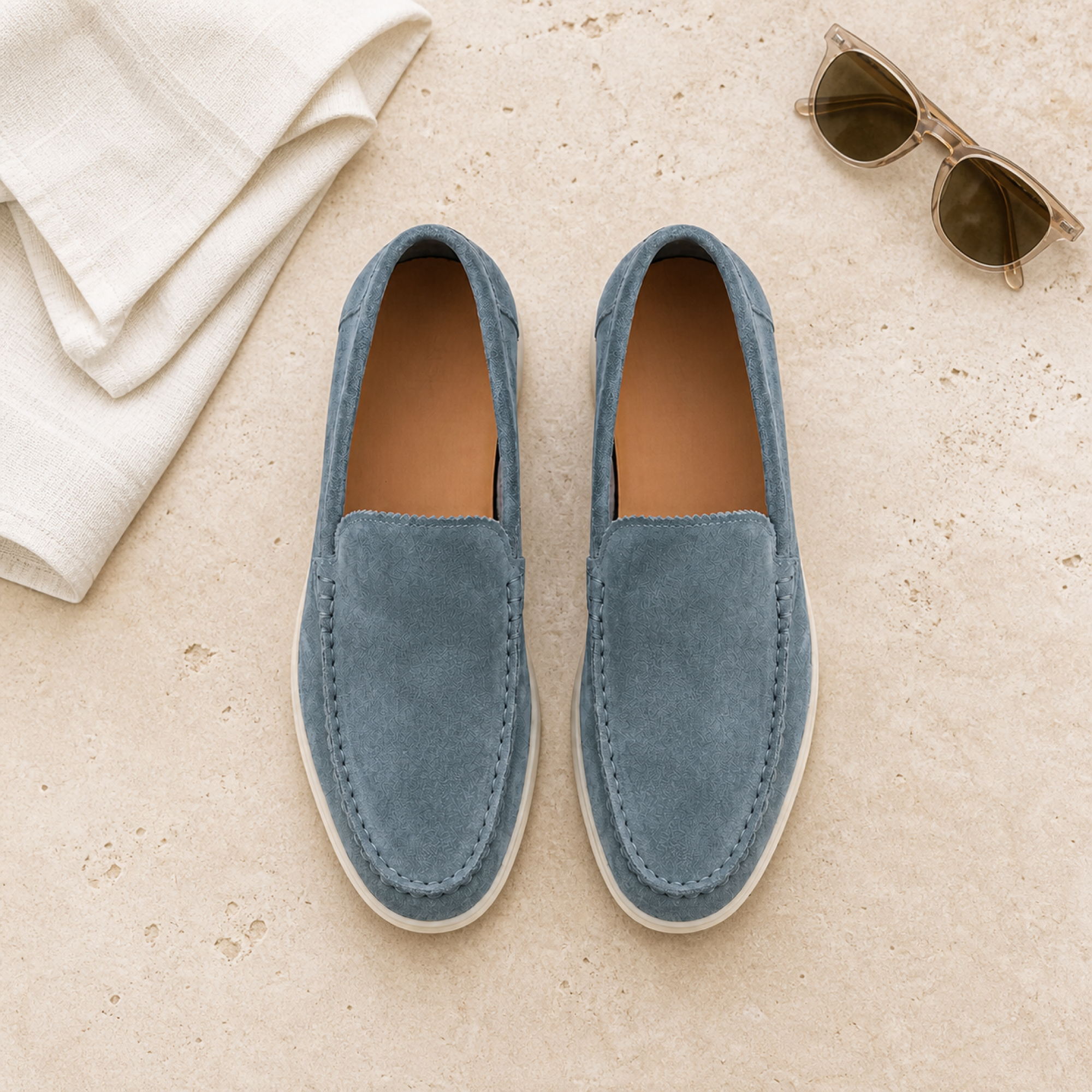 Bellaro petrol-blue suede loafers in luxury travertine flat lay