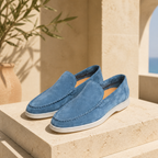 Bellaro sapphire blue loafers on travertine editorial setting