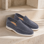 Bellaro steel-blue moc-toe loafers on travertine steps
