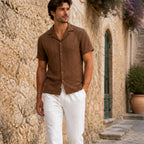 Belnor coffee and ivory resort set styled beside a Mediterranean stone wall