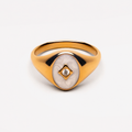 Gold-tone oval signet ring with white inset and clear stone, unbranded
