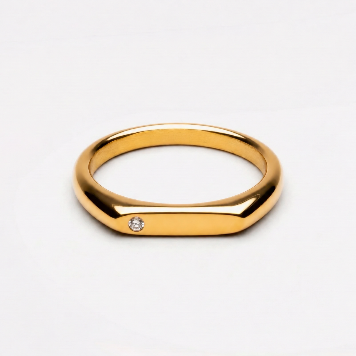 Gold ring with small round clear stone
