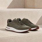 Caldris olive mixed-panel runner sneakers on sunlit travertine