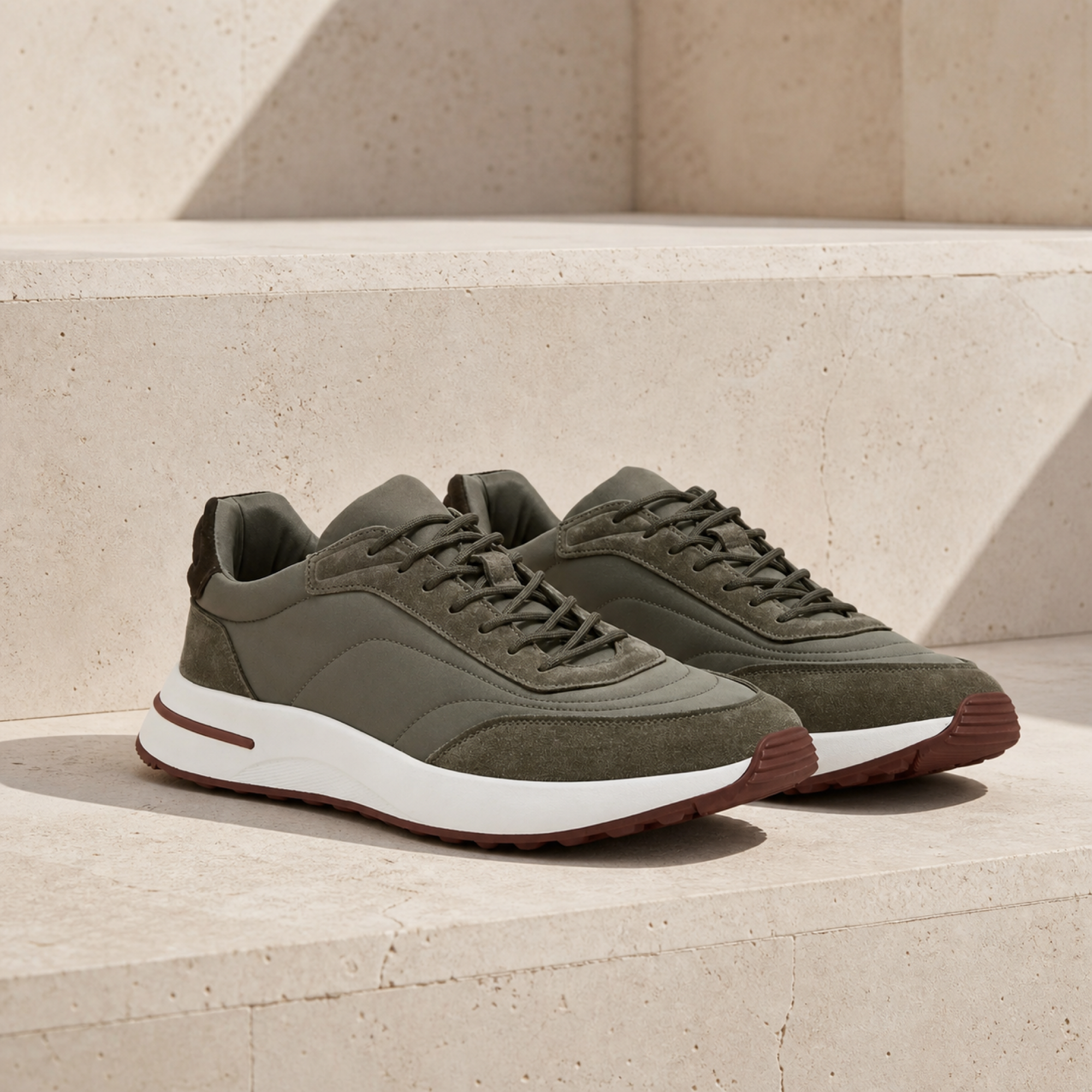 Caldris olive mixed-panel runner sneakers on sunlit travertine