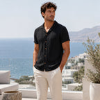 Corlian black shirt styled on a coastal rooftop