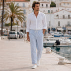 Man wearing Corvento striped trousers on Mediterranean marina promenade