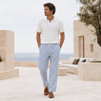 Man wearing Corvento striped trousers on limestone sea terrace