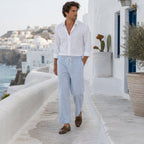Man wearing Corvento striped trousers in whitewashed coastal village