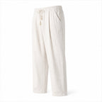 Dorevane white relaxed cotton trousers, angled studio view