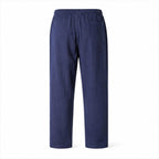 Dorevane navy relaxed cotton trousers, rear studio view