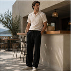 Dorevane black trousers styled at a coastal cafe