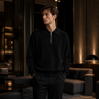 Man wearing black Fiorsaro knit polo in an evening lounge