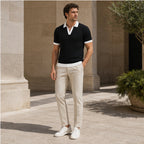 Fiorvello black knit polo styled in a limestone courtyard