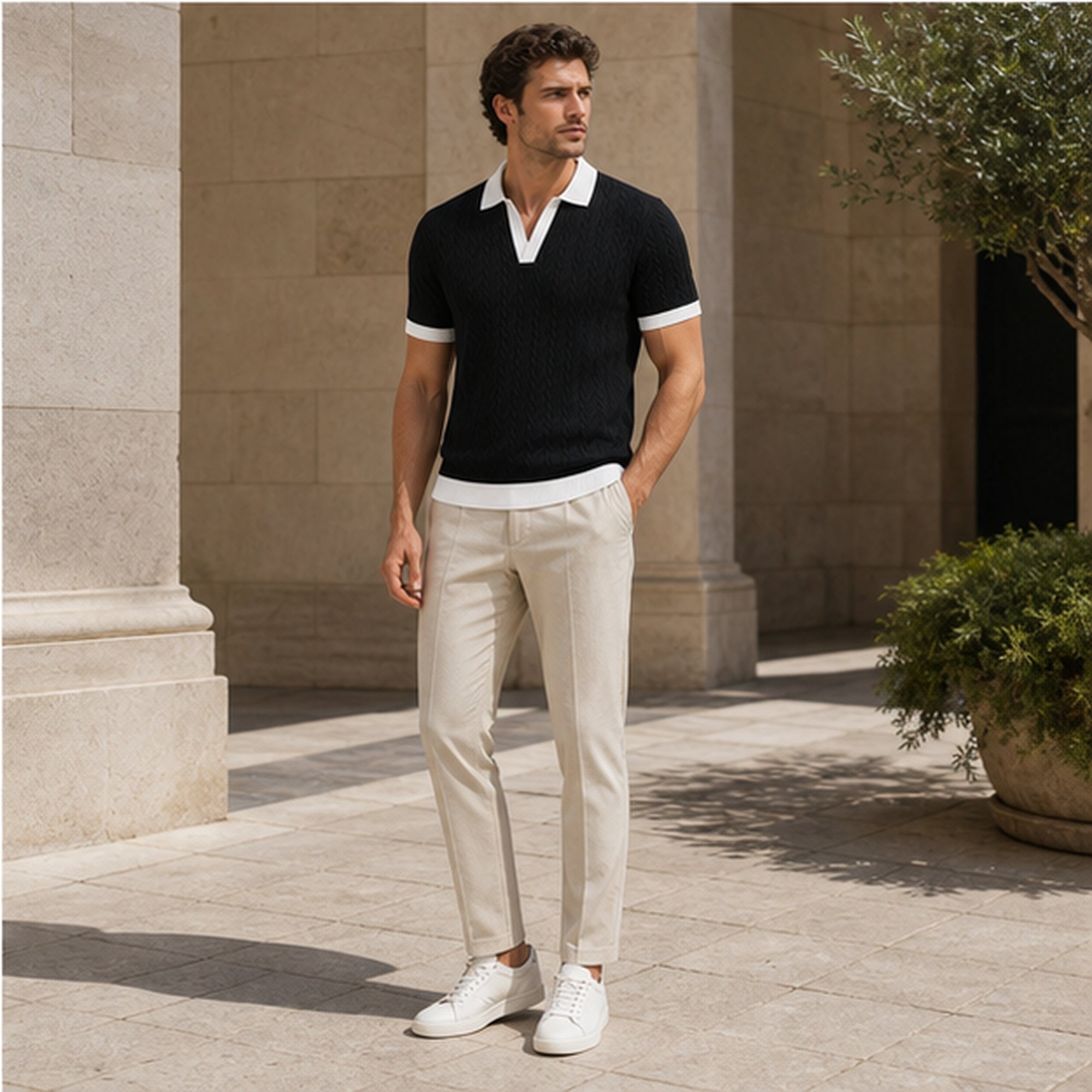Fiorvello black knit polo styled in a limestone courtyard