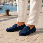 Man wearing Averino navy penny driver loafers at a marina