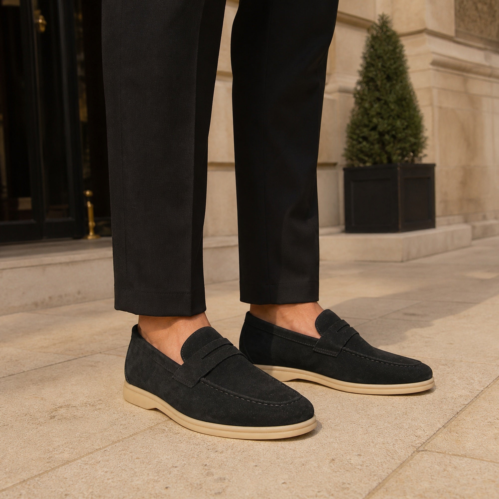 Man wearing Cormont black penny loafers with tailored trousers