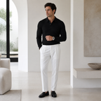 Man wearing black Galrino polo in a refined residence
