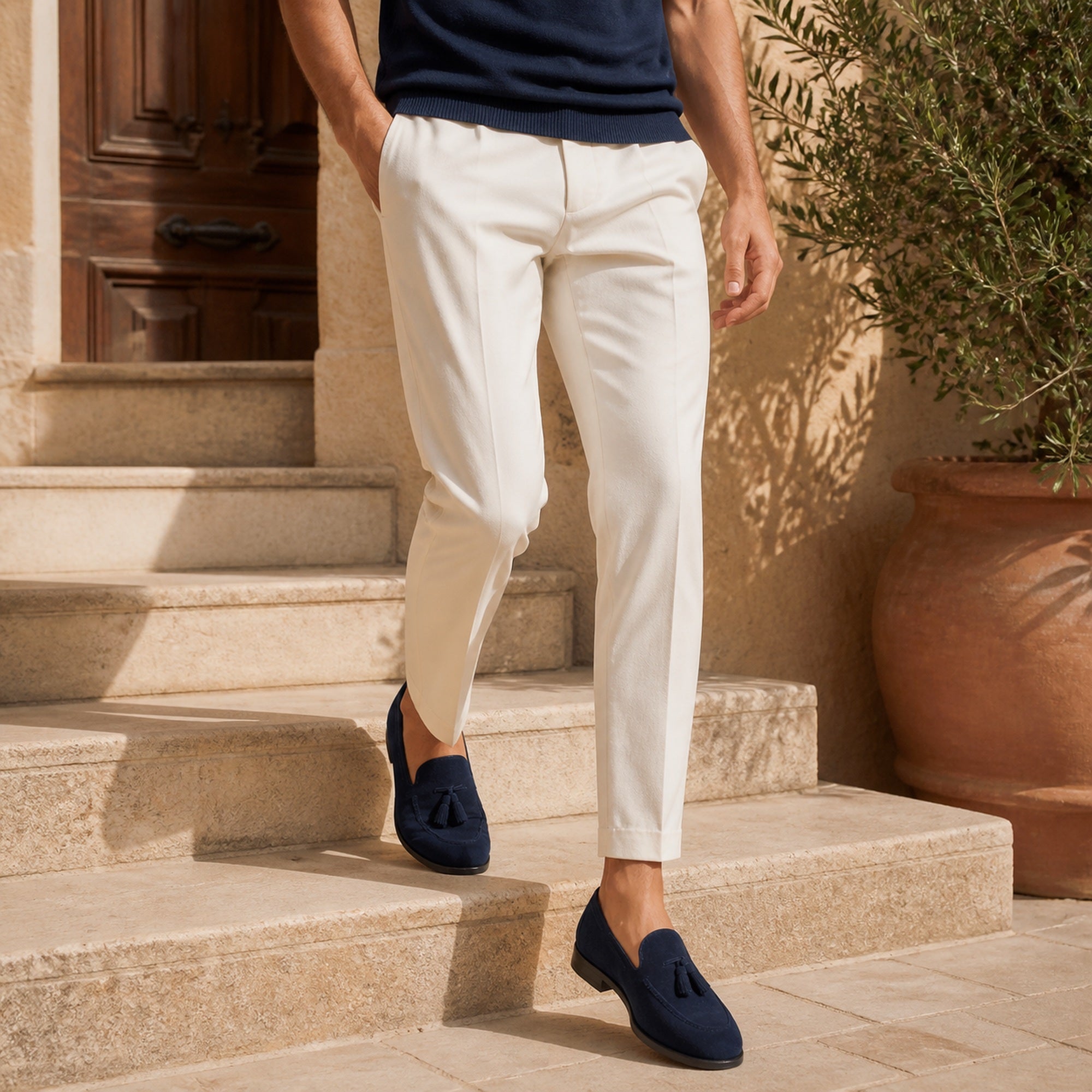 Harnor navy suede loafers styled with ivory trousers on limestone steps