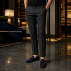 Harnor navy suede loafers styled with charcoal trousers in a hotel lounge