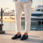 Harnor navy suede loafers styled with linen trousers at a marina