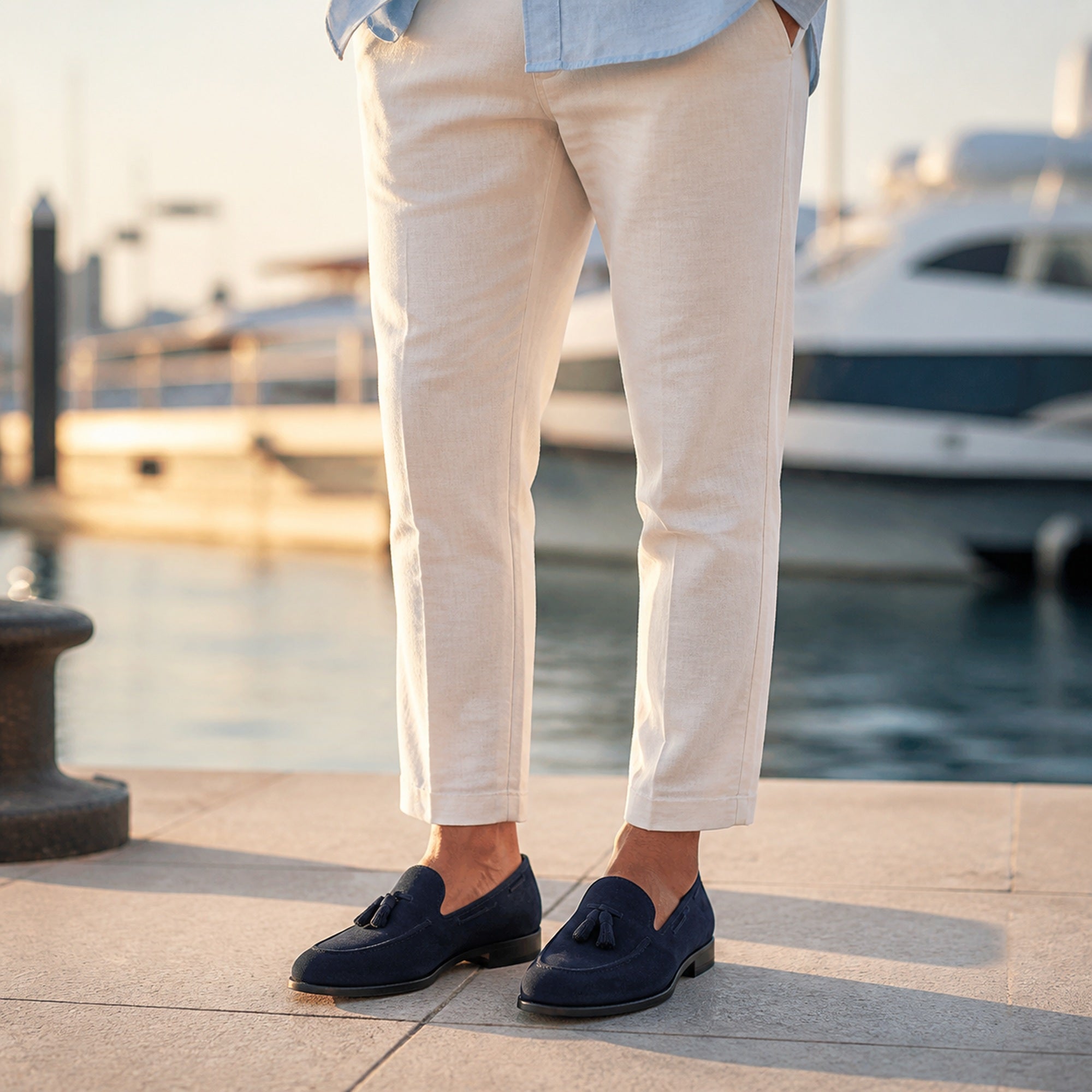 Harnor navy suede loafers styled with linen trousers at a marina