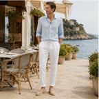Harrino white linen-cotton trousers at coastal cafe