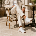 Bruce & Co Aerivo white sneakers in a refined café setting