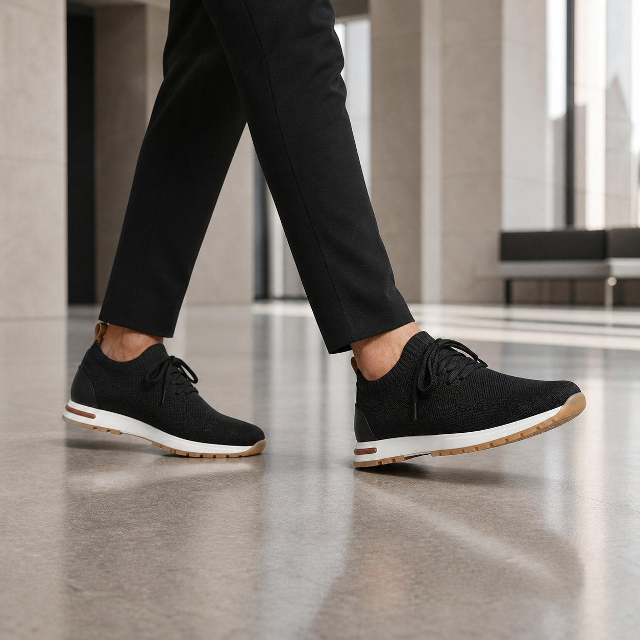 Men's black knit sock-fit sneakers in a refined lobby