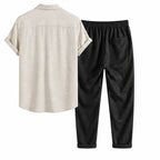 Lorvaro beige shirt and black trousers studio rear view