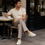 Bruce & Co Norvane beige slip-on sneakers in a cafe editorial