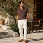 Man wearing the Orlian coffee outfit on a Mediterranean terrace