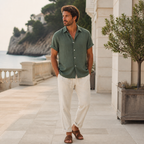 Man wearing the Orlian green outfit at a coastal resort