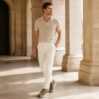 Orvessa olive suede-mesh runners styled in a Mediterranean colonnade