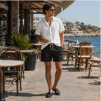 Palelian white shirt and black shorts styled in a coastal cafe