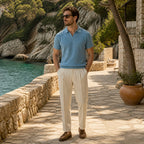 Quinrel muted teal polo styled on a Mediterranean cove walkway