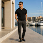 Quinrel black polo styled beside modern marina architecture