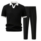 Quinvane black textured Johnny-collar polo and black tapered trousers, studio front