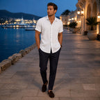 Rovevaro white shirt styled on a waterfront promenade at blue hour
