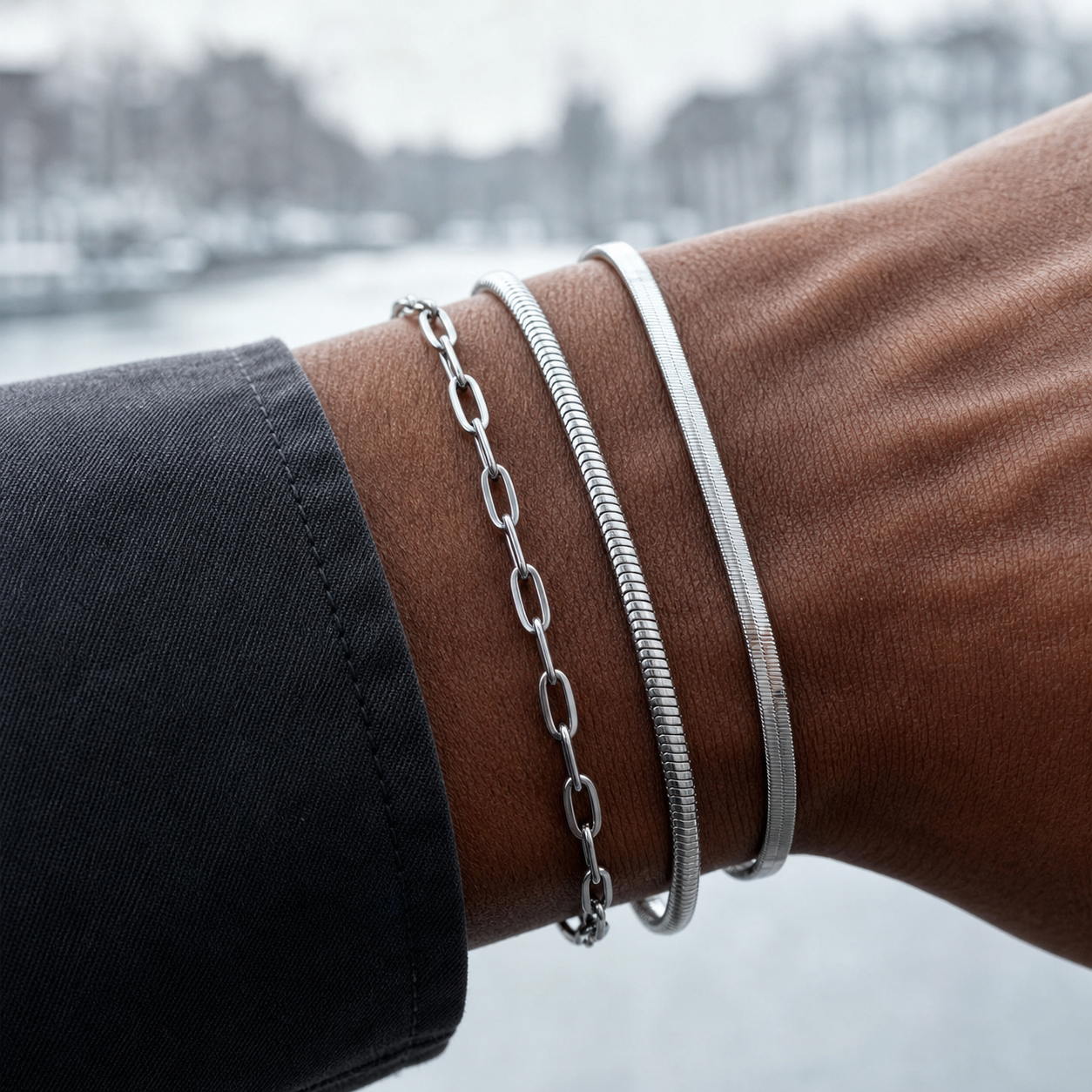 Close editorial view of three layered silver bracelets