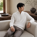Man wearing the white Taverino sweater in a refined villa interior