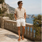 Tavesaro men's beige shirt and white shorts set on a coastal terrace