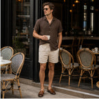 Tavesaro men's coffee shirt and beige shorts set at a European cafe
