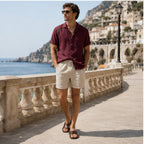 Tavesaro men's maroon shirt and beige shorts set on a coastal promenade