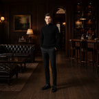 Urenor black sweater styled in a private club interior
