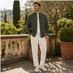 Urerino men's dark green shirt and off-white trousers on an Italian terrace