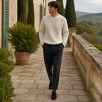 Man wearing the white Urevento sweater on a Mediterranean villa terrace
