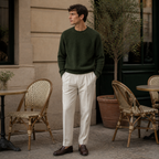Man wearing the green Urevento sweater at a European cafe terrace